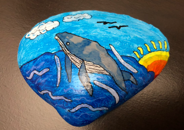 Cartoon art whale breaching painted on shell