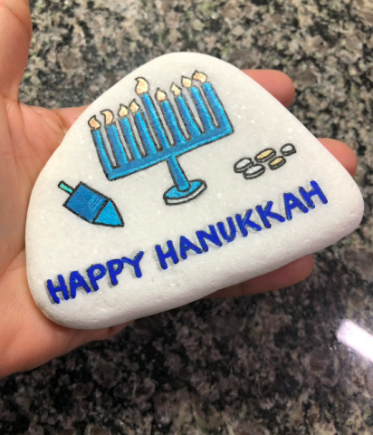 Happy Hanukkah painted in blue and gold santorini rock