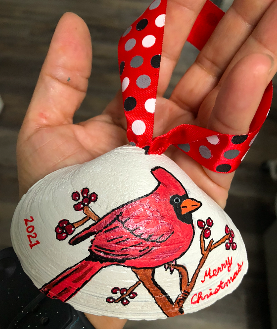 Red robin painted on shell ornament
