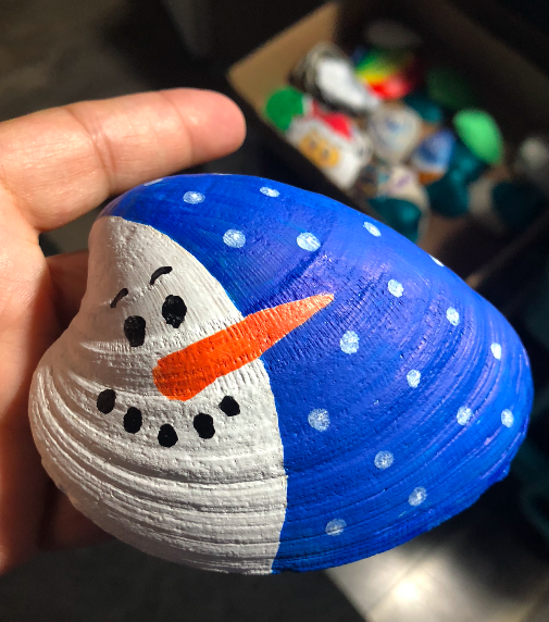 A snowman painted on a clam shell