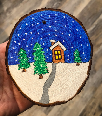 winter scene painted on a wood slice
